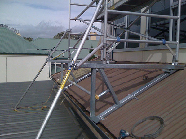 When erecting a mobile scaffold on a roof, the scaffold must be secure at he bottom and erected plumb.