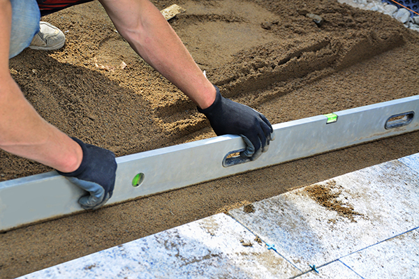 Bend at the knees to avoid back injury when screeding sand. Do not overreach to avoid Muscle strain - musculoskeletal disorders.