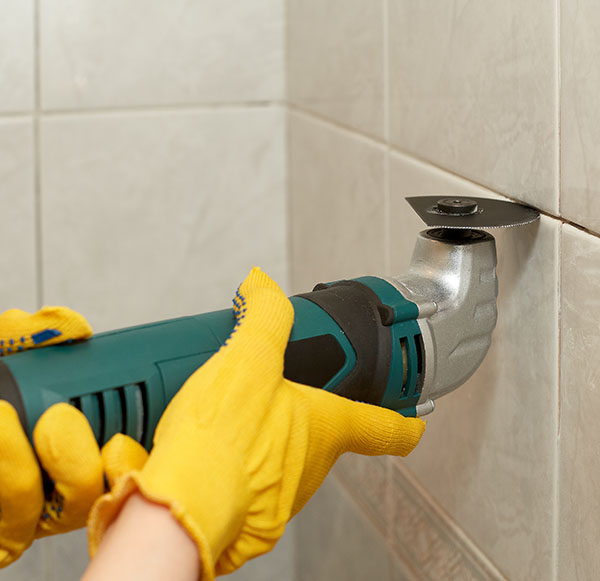 The use of electric grout removal tools carries risks, including the possibility of electrical shocks and harms resulting from spinning blades.