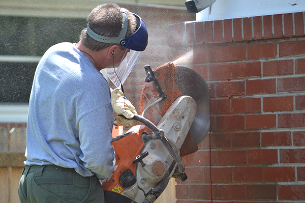 When using a quick-cut demolition saw, prioritize safety by wearing appropriate PPE!