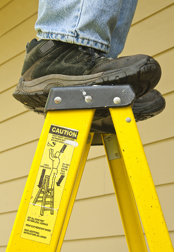 It is not safe to stand on the top rung of a ladder