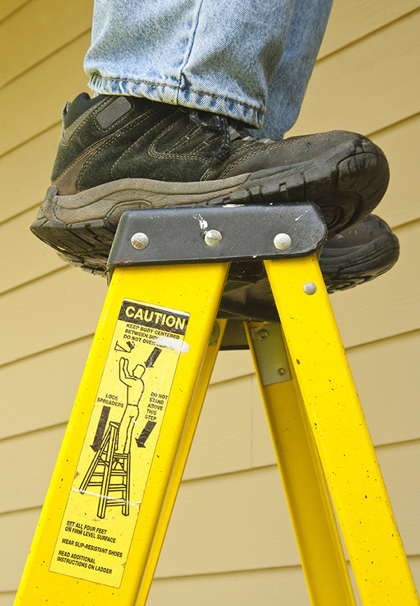 It is not safe to stand on the top rung of a ladder.